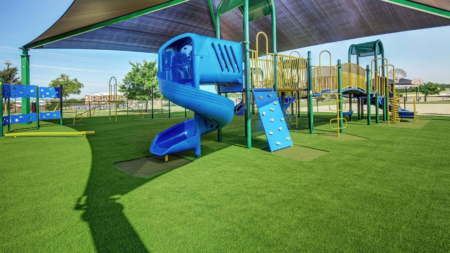 Blue slide on artificial playground grass