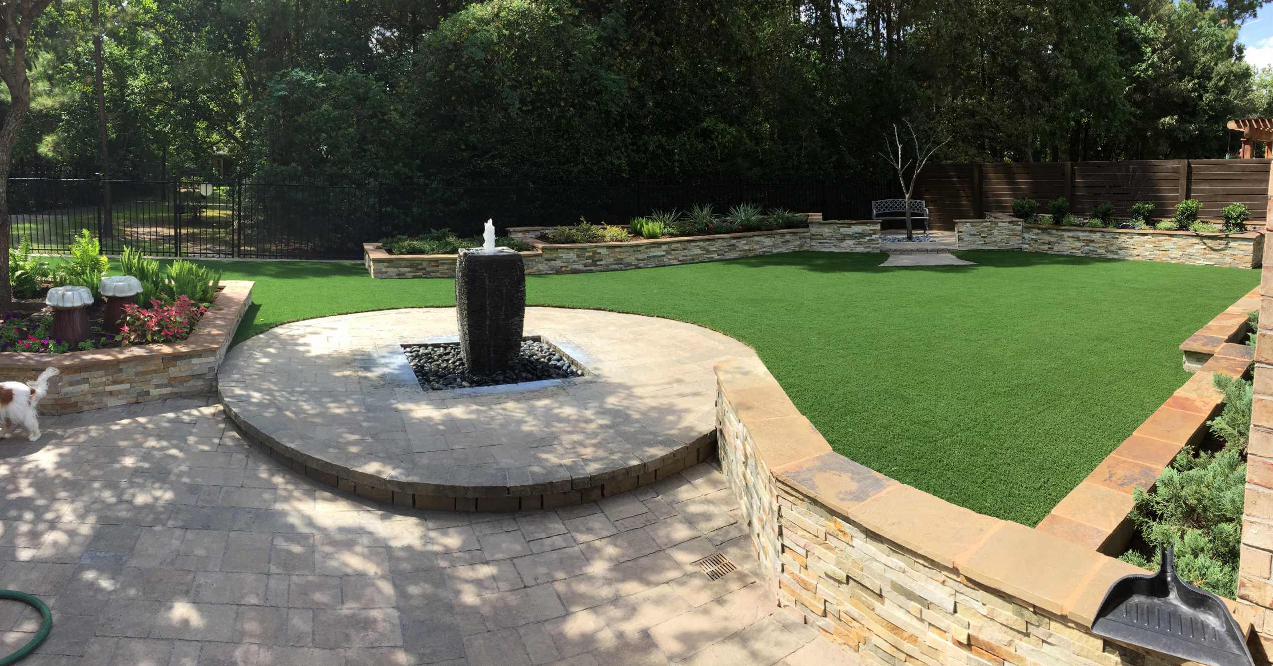 residential fountain backyard with artificial grass