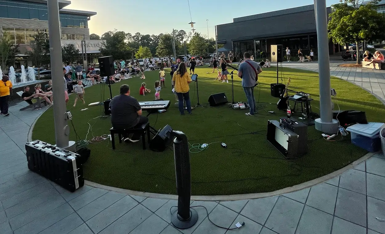 Band playing on commercial artificial grass at eastover district